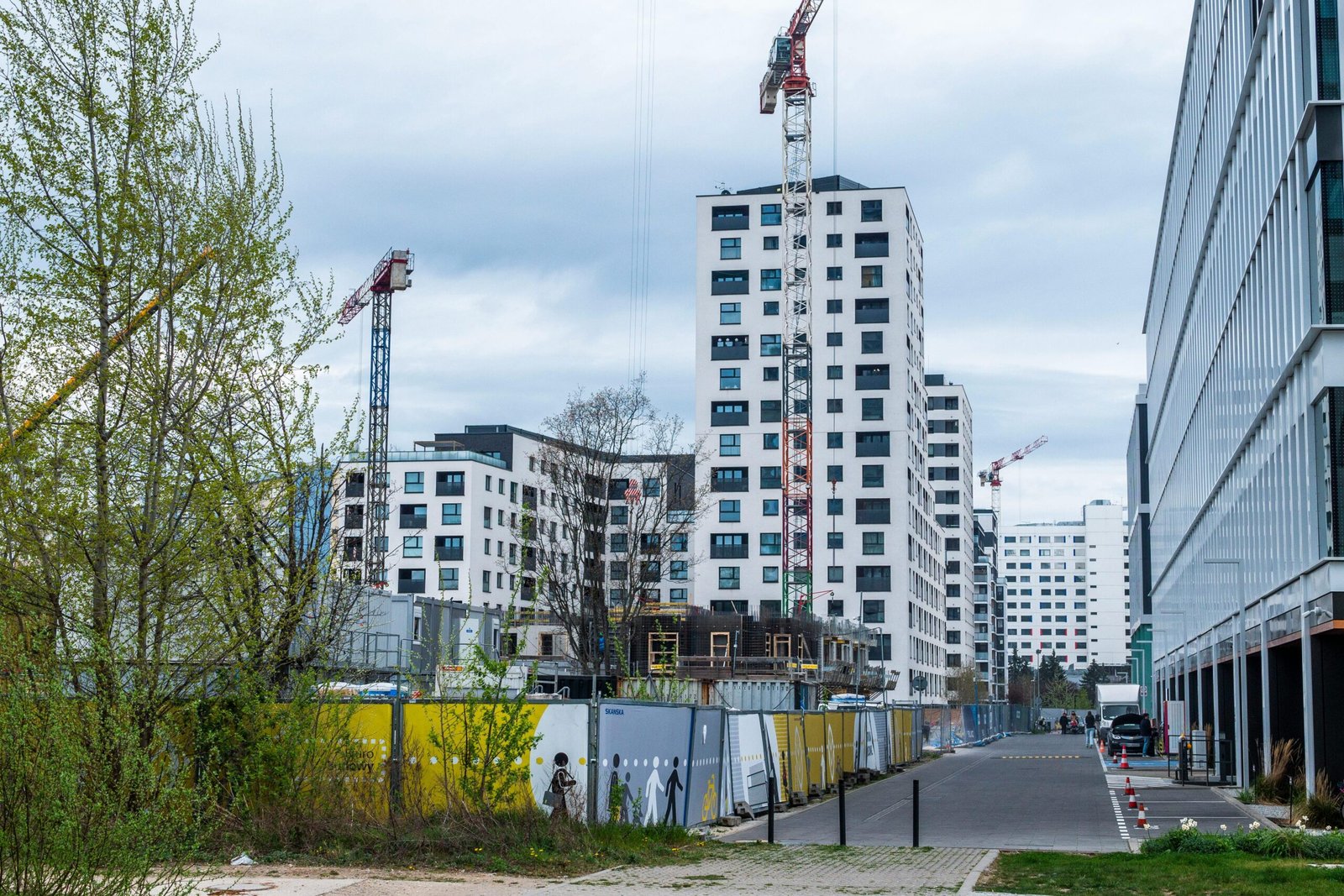 High-rise buildings and cranes in an urban construction site. Modern architecture.